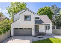 Charming two-story home with gray trim, attached garage, well-kept lawn, and beautiful landscaping at 2640 Overlook Dr, Broomfield, CO 80020