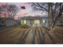 Charming single-story home featuring a well-manicured front yard and inviting curb appeal at 1975 S Hooker Cir, Denver, CO 80219
