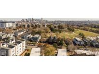 Stunning aerial view of a modern neighborhood with downtown skyline, a vibrant park and beautiful tree-lined streets at 1346 N Knox Ct, Denver, CO 80204