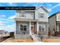 Charming two-story home featuring a welcoming front porch and modern stone accents at 21209 E 62Nd Ave, Aurora, CO 80019