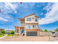 Beautiful multi-story home with a modern design, attached garage, and a well-maintained brick driveway at 18651 E 53Rd Ave, Denver, CO 80249