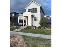 Charming two-story home featuring modern design elements and beautifully landscaped front yard at 6237 Stable View St, Castle Pines, CO 80108