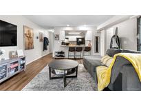 Inviting living room boasts an open floor plan and seamless flow to the kitchen, creating a comfortable and stylish living space at 16001 E Alaska Pl # 12, Aurora, CO 80017