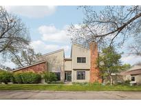 Charming two-story home with brick chimney, well-maintained landscaping and an inviting facade at 7925 W Layton Ave # 500, Littleton, CO 80123