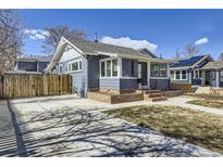 Charming home featuring new gray paint, a brick foundation, and a well-manicured front yard at 4441 N Meade St, Denver, CO 80211