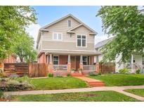 Charming two-story home with a welcoming front porch and well-maintained lawn at 3864 Osceola St, Denver, CO 80212
