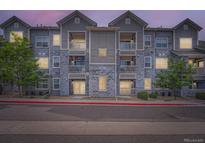 Charming apartment building with grey stone and white trim, offering a modern living space at 1831 S Dunkirk St # 103, Aurora, CO 80017