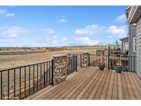 Inviting wooden deck with stone pillars offers expansive views of the surrounding landscape at 15076 W 93Rd Ave, Arvada, CO 80007