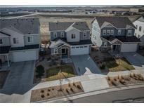 Charming two-story home with stone accents, a well-manicured lawn, and an attached two-car garage in a desirable neighborhood at 15076 W 93Rd Ave, Arvada, CO 80007