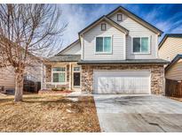 Charming two-story home with stone accents, attached two-car garage, and covered porch at 257 Cherry St, Castle Rock, CO 80104