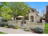 Charming home featuring a gated courtyard with lush landscaping and inviting outdoor living space at 520 Jackson St, Denver, CO 80206