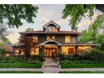 Charming two-story home with brick exterior, landscaped yard, and inviting front porch at 1500 E 7Th Ave, Denver, CO 80218