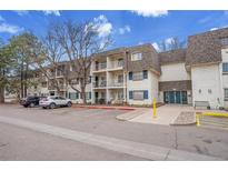 Attractive condo building with brick facade, balconies, and ample parking in a well-maintained community at 5995 E Iliff Ave # 308, Denver, CO 80222