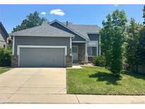 Charming single-Gathering home with an attached garage, well-maintained lawn and mature landscaping at 19688 E Lasalle Dr, Aurora, CO 80013
