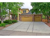 Inviting two-story home featuring a brick facade, a spacious driveway, and well-maintained landscaping at 2631 E 136Th Pl, Thornton, CO 80602
