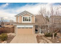 Charming two-story home featuring a two-car garage and well-maintained front yard in a suburban neighborhood at 3001 White Oak Trl, Highlands Ranch, CO 80129