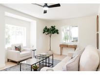 Open living room featuring leafy tree, light, and comfortable furniture at 1361 W Custer Pl, Denver, CO 80223