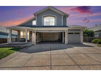 Charming two-story home featuring stone accents, a covered porch, open garage space, and a well-maintained lawn at 6833 E 115Th Ave, Thornton, CO 80233