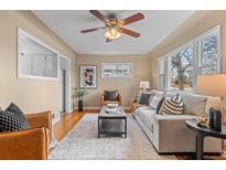 Bright living room featuring a comfortable sofa, stylish decor, and ample natural light at 2248 Lima St, Aurora, CO 80010