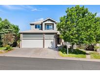 Charming two-story home with a three car garage, and mature landscaping at 9745 Hummingbird Pl, Littleton, CO 80125
