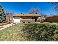 Charming brick ranch-style home with attached garage and mature trees in a well-maintained neighborhood at 620 Newport St, Denver, CO 80220