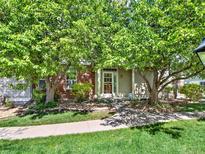Charming home featuring mature trees, a brick facade, and well-maintained landscaping at 3426 W 98Th W Dr # A, Westminster, CO 80031