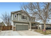 Charming two-story home with a well-maintained front yard and covered entry porch at 10529 Vaughn Way, Commerce City, CO 80022