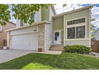 Charming two-story home with a two car garage, a well-manicured lawn, and lush landscaping at 9661 Autumnwood Pl, Highlands Ranch, CO 80129