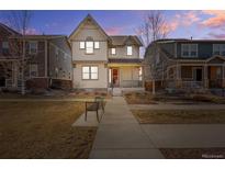 Charming two-story home with a landscaped front yard at dusk at 540 E Fremont Pl, Centennial, CO 80122