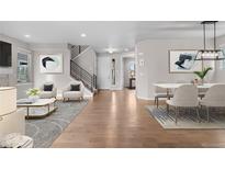 Inviting living space with hardwood floors, a staircase, modern decor, and abundant natural light at 540 E Fremont Pl, Centennial, CO 80122