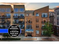Charming condo building featuring brick facade, balconies, and mature trees and offering 3 months paid HOA dues at 7240 W Custer Ave # 303, Lakewood, CO 80226