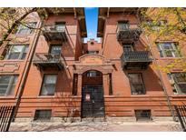 Charming brick apartment building featuring wrought iron balconies and secured entry in the 