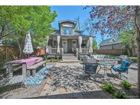 Inviting backyard retreat with stylish patio furniture and a charming covered porch at 1027 S University Blvd, Denver, CO 80209