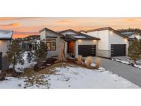 Modern two-story home with attached two-car garage and landscaped front yard at 5191 Copper Blush Ct, Castle Rock, CO 80108