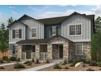 Charming two-story home featuring stone accents, a welcoming front porch, and neutral-colored siding at 24151 E 52Nd Ave, Aurora, CO 80019