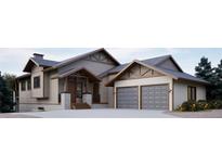 Striking two-story home featuring a three-car garage, stone accents, and craftsman-style details at 680 Lone Eagle Dr, Granby, CO 80015