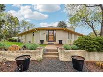 Charming home with an updated brick facade, landscaped front yard, and welcoming entrance at 1118 Eagle Rd, Broomfield, CO 80020