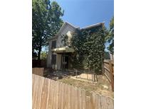 Exterior view of a two story home with climbing ivy and a covered porch at 1901 N Emerson St, Denver, CO 80218