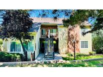 Inviting exterior showcasing a well-maintained, two-story townhouse with charming brick accents and manicured landscaping at 13894 E Lehigh Ave # G, Aurora, CO 80014