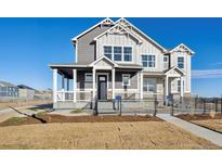 Two-story home with gray siding, white trim, and a front porch at 934 Andrews Crest Dr, Berthoud, CO 80513