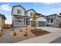 Two-story house with gray siding, stone accents, and a landscaped front yard at 3432 N Gold Bug Ct, Aurora, CO 80019