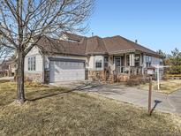 Charming single-story home with a two-car garage, stone accents, and a inviting front porch at 7890 S Quatar, Aurora, CO 80016