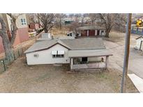 Aerial view of a house and surrounding land with various outbuildings at 7110 Colorado Blvd, Commerce City, CO 80022