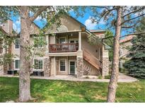 Inviting exterior view showcasing stone accents and a charming second-story balcony at 4085 S Crystal Cir # 104, Aurora, CO 80014