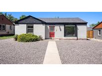 Charming single-story home with a red front door, grey exterior, and manicured gravel yard at 1355 Rosemary St, Denver, CO 80220