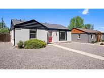 Charming exterior with grey stucco, red door, and gravel landscaping at 1355 Rosemary St, Denver, CO 80220