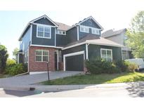 Charming two-story home with a well-maintained lawn and an attached two-car garage at 1710 S Poplar St, Denver, CO 80224