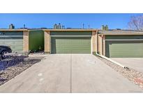 Attached garage with a long driveway and stone landscaping at 7077 S Bryant St, Littleton, CO 80120
