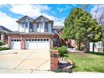 Charming two-story home with well-maintained lawn, a large shade tree and three-car garage at 16627 W 1St Ave, Golden, CO 80401