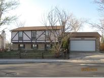 Ranch style home with attached garage and landscaping at 16651 E Arizona Pl, Aurora, CO 80017